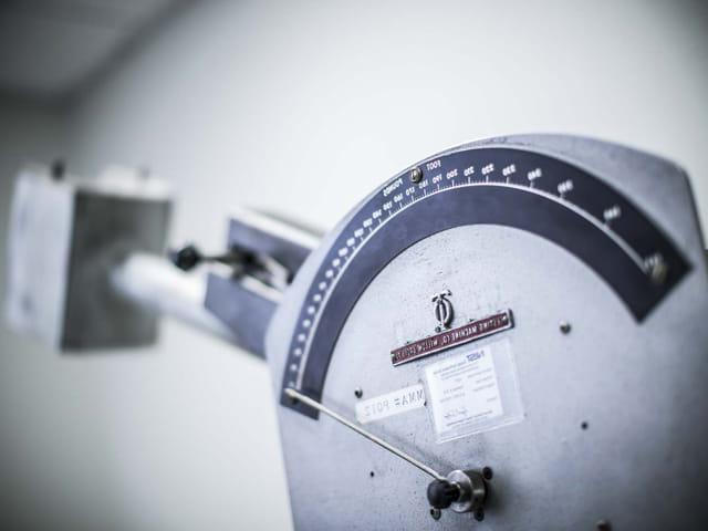 Measuring impact testing using Charpy Impact machine within a materials testing laboratory.